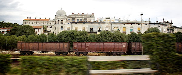 train in front of a villa and bushes