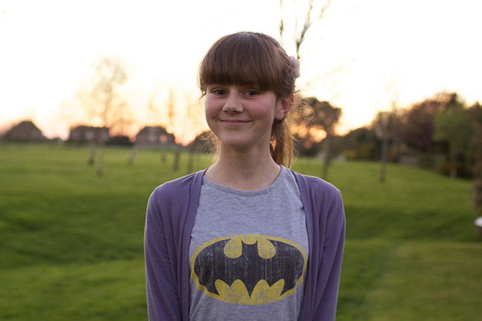 A portrait of a young girl posing outdoors, demonstrating adjusting white balance in photography