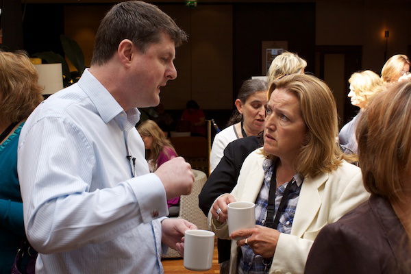 A candid shot of a man conversing with a woman