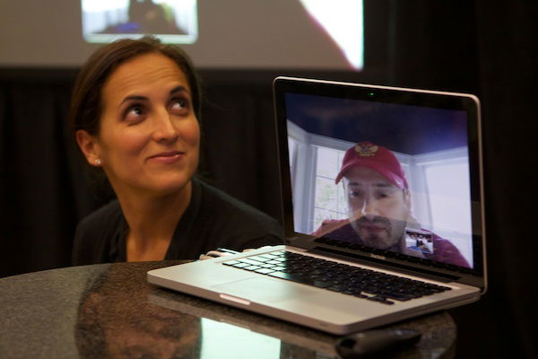 An image of a woman and a man on the laptop