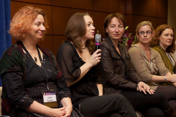 A line of women surround the speaker - Corporate Event Photography