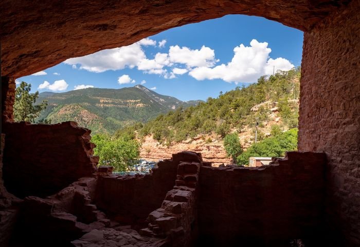 Photo of hills shot from inside a cave using frame within a frame composition