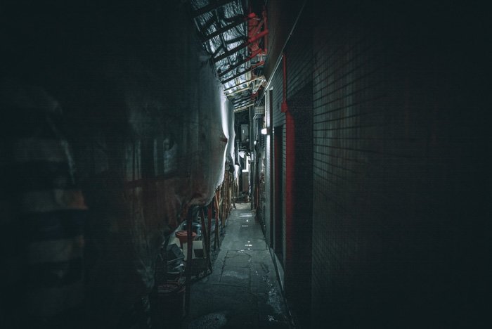 Atmospheric low light photography shot of an industrial alleyway