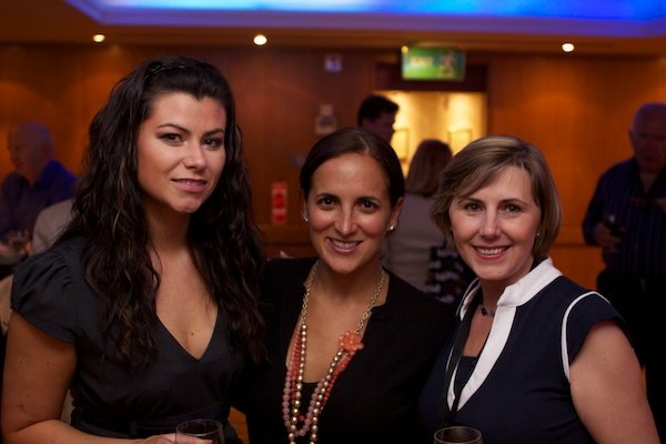 three woman smiling for a photo at an event