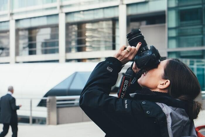 Photo of a woman taking a photo with a camera