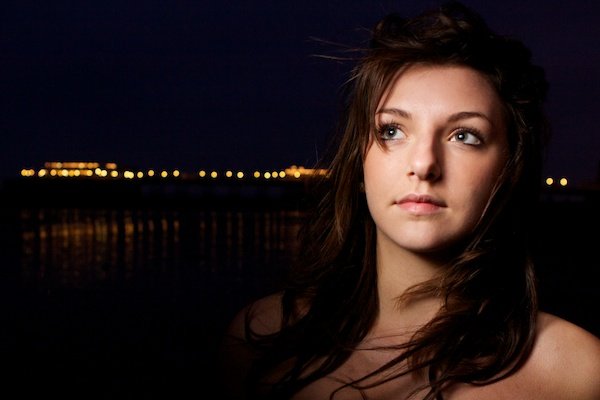 Portrait photography of a girl on a beach at night. Twilight photography.