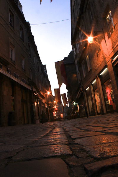 Low angle shot of a city street in low light, with a diagram showing the use of triangles in photography composition 