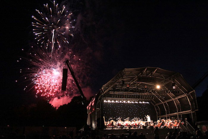 A fireworks display beside an outdoor stage - balance photography definition 