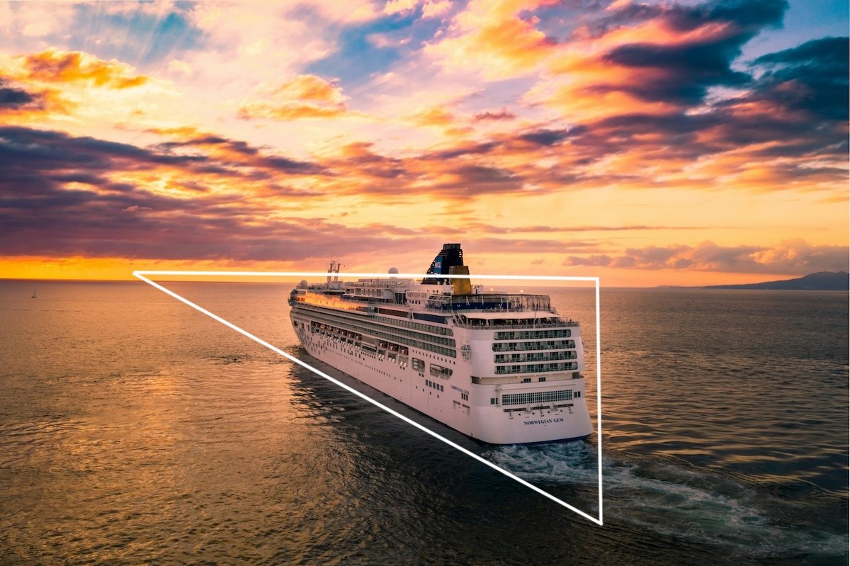 A cruise ship sailing towards a sunset showing triangles in photography