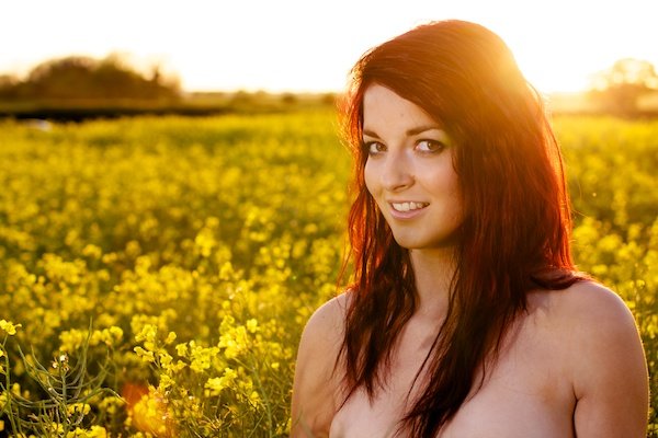 Photo of a young woman in the field of yellow flowers demonstrating editing with black point