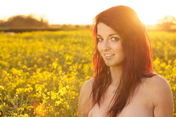 Photo of a young woman in the field of yellow flowers demonstrating editing with white balance