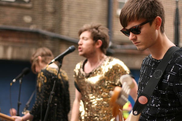 portrait photography of three musicians during an outdoor concert