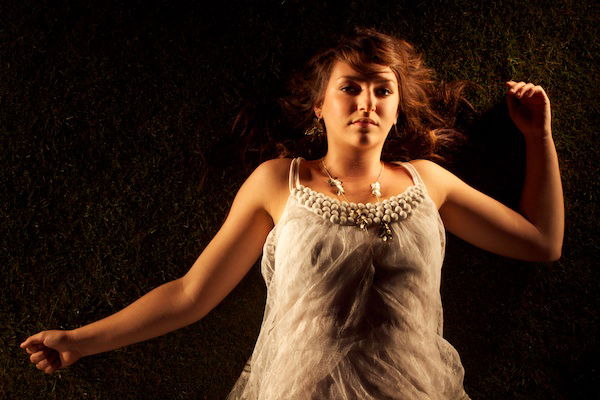 An overhead portrait of a girl lying on the ground at night - how to critique your photos