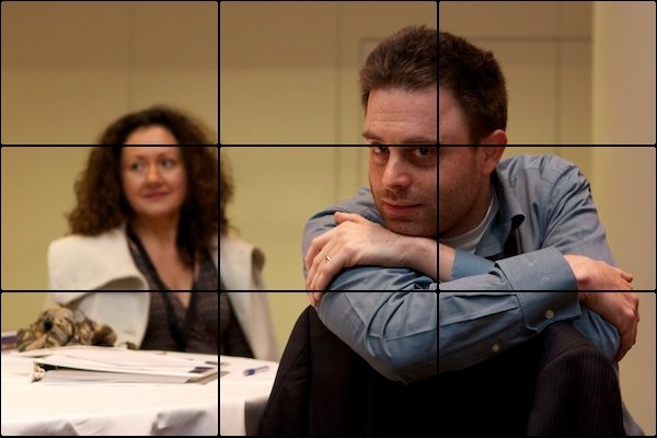 A picture of a man and woman with the man being in focus. The picture is divided up into rectangles.