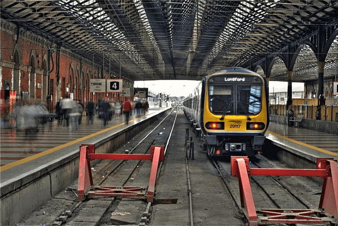 A train station with blurred people on the left