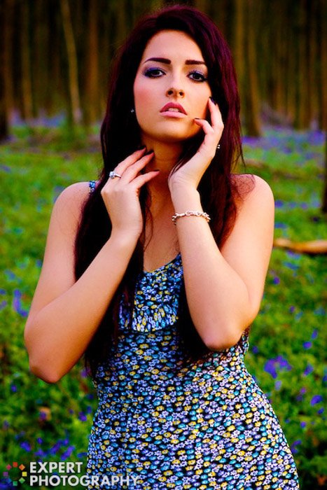 A portrait of a female model posing outdoors