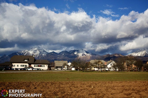 beautiful mountains with ordinary suburban houses, grass, clouds