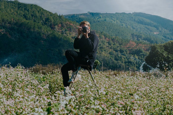 Amateur photographer in a field of flowers