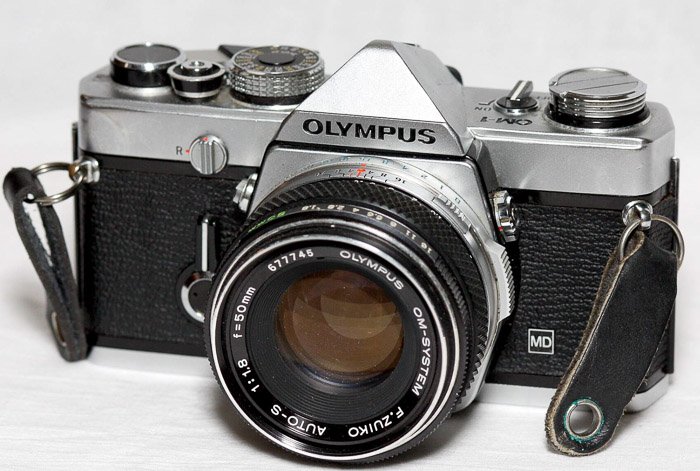 Film/vintage Camera - Olympus OM-1 MD on white background