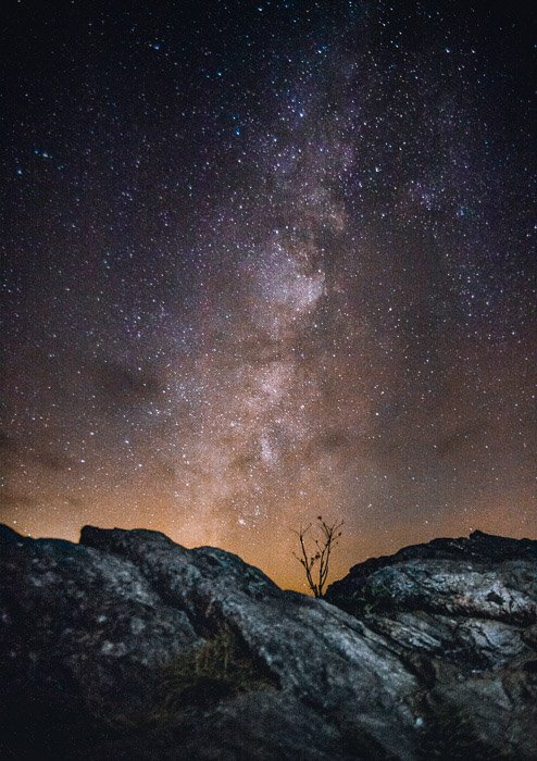 A stunning star filled sky over a rocky landscape