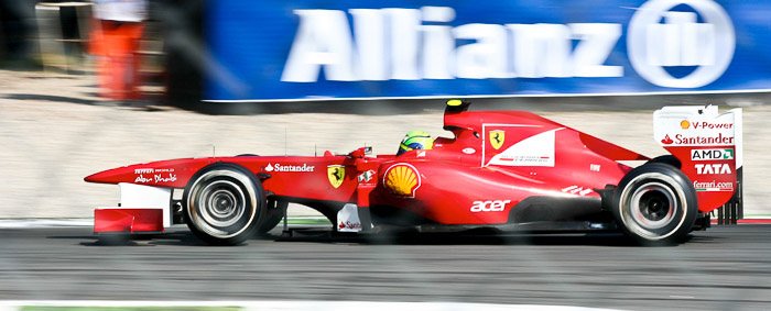 A red race car at the 82th Italian GP in Monza featuring creative motion blur