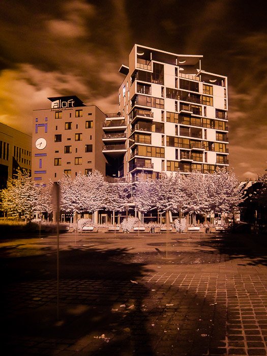 An amber tinted infrared photography shot of The aloft Hotel in Brussels (Belgium).