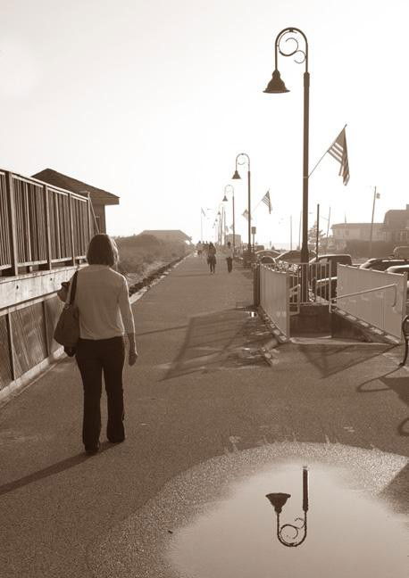 An image of a woman walking down a road where shadows are prevalent - Photography Projects to Do with Children