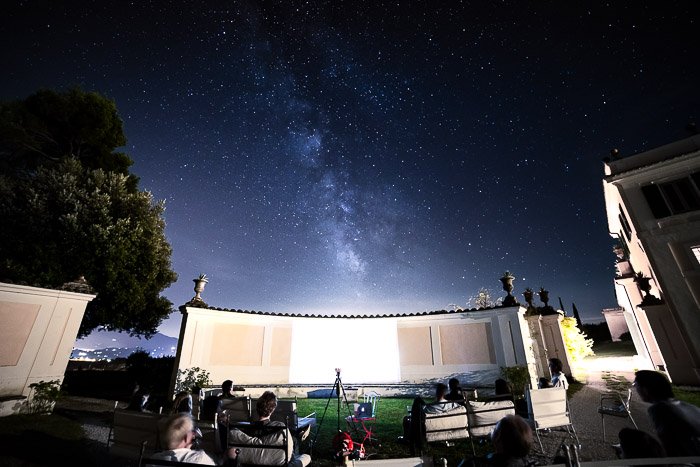 Stunning astrophotography shot of a star filled sky above an outdoor event area
