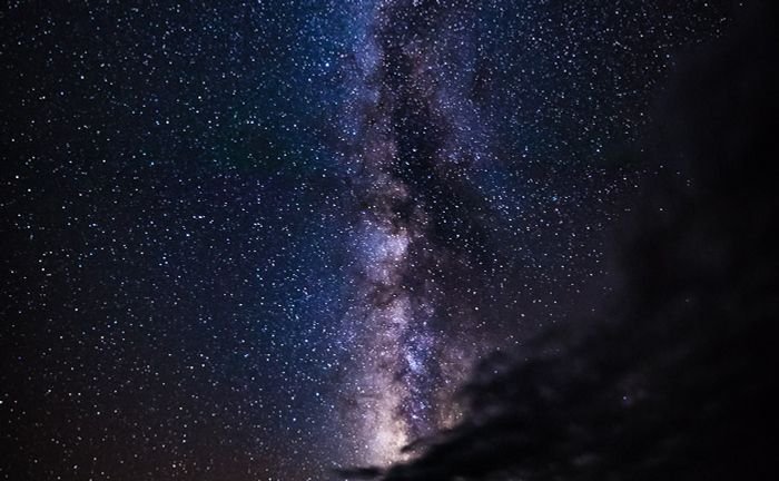 The night sky with the Milky Way appearing vertically