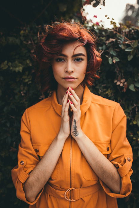 Outdoor portrait photo of a girl in a yellow coat