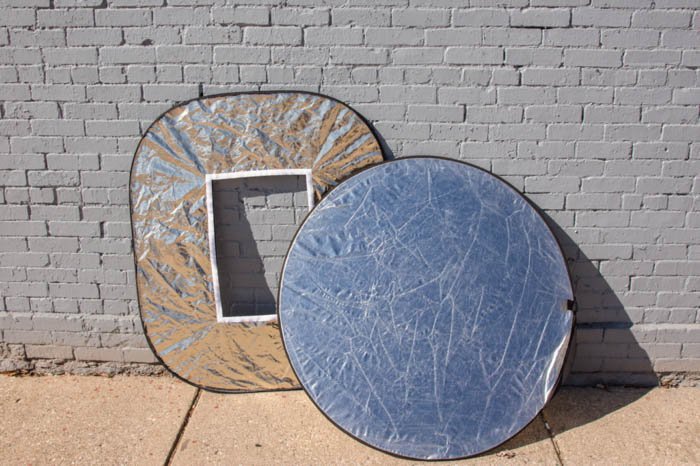 Photo of two reflectors in front of a brick wall
