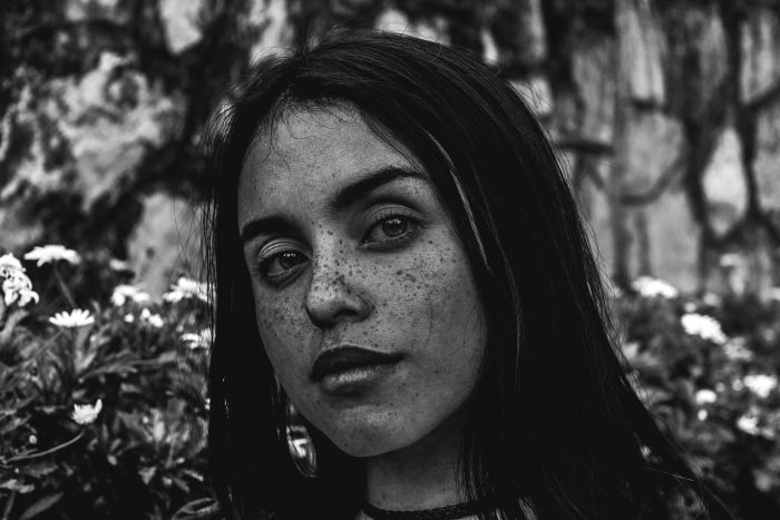 Black and white portrait of a woman with freckles 