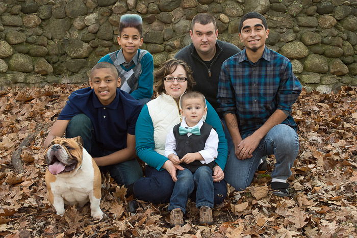 A family portrait of six people posing with the Family Pets