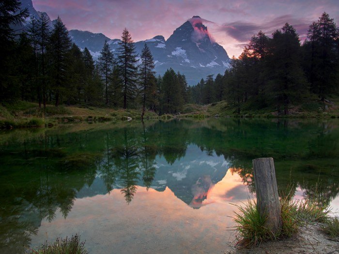 landscape image of Matterhorn peak in the Alps mountains with lake reflection at the front