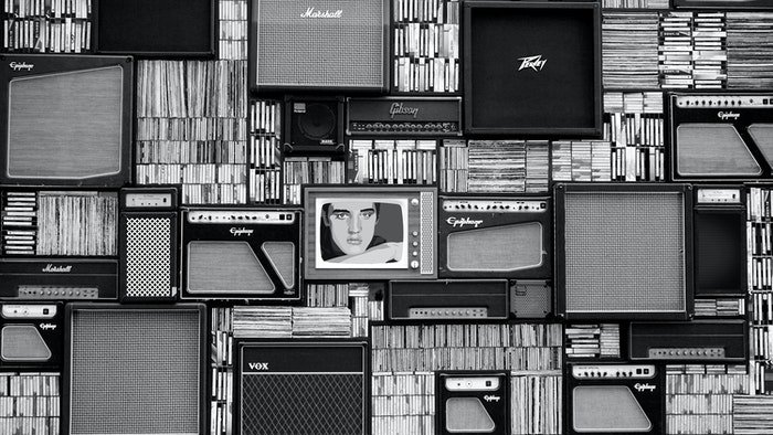 black and white image of old speakers and books
