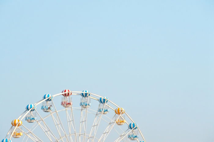 The top of a ferris wheel against a blue sky 