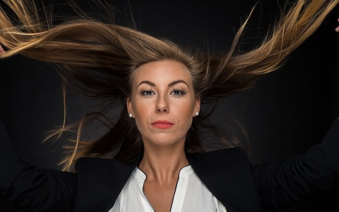 Portrait lighting: medium shot of woman with wind-blown hair