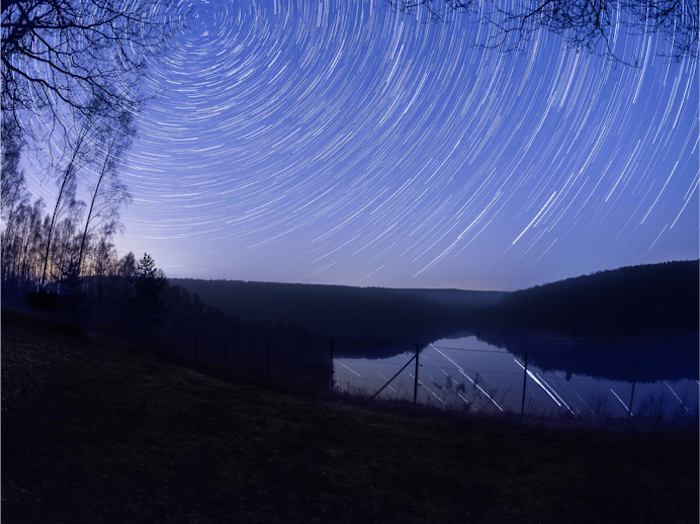 A star trail background with uninteresting foreground