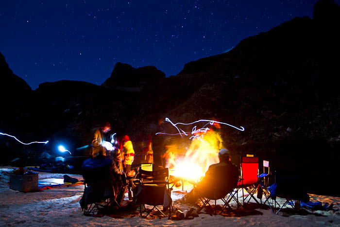 Photo of people around a campfire, showing camp life during outdoor photography