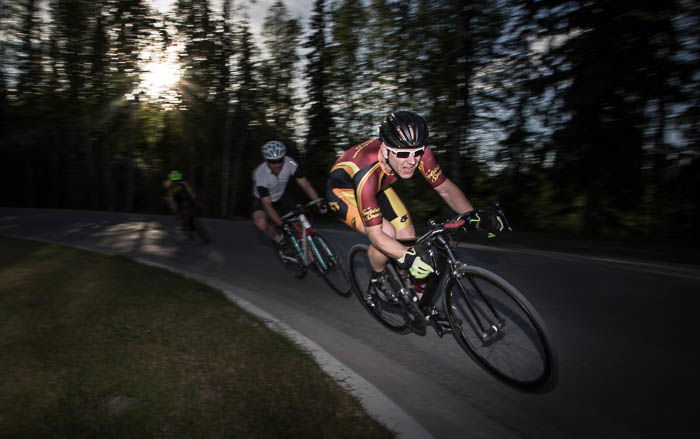 Straight view at a cyclist coming into a turn during a cycling race.