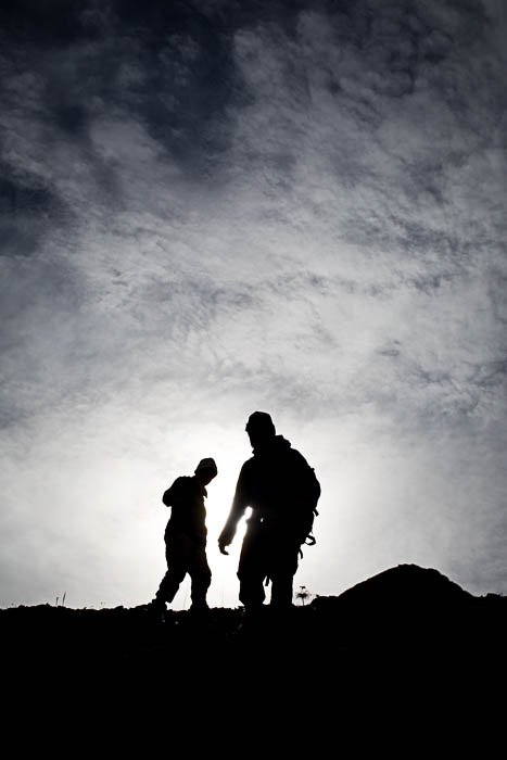 The silhouettes of two men photographed at Katakturuk River