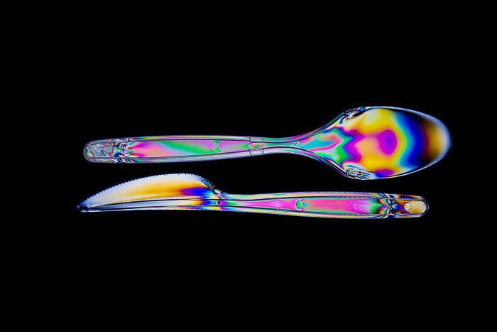 Rainbow effects passing through plastic cutlery with photoelasticity.