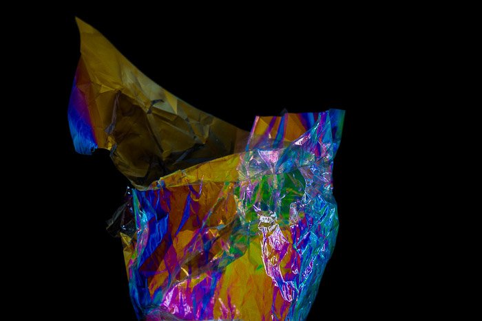 Food wrapper displaying abstract color effects from photoelasticity 