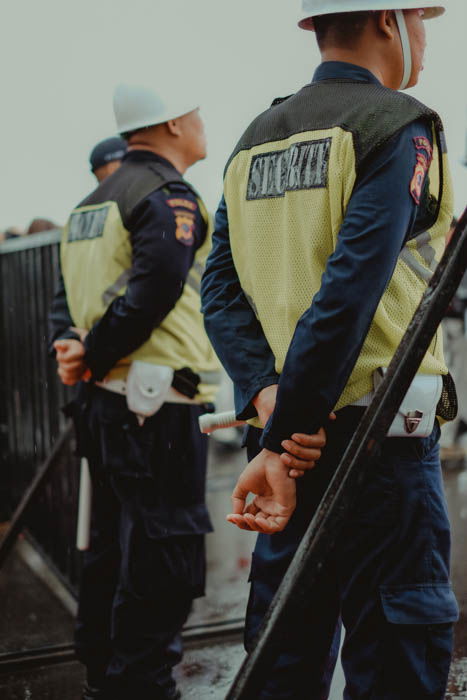 Two security guards photographed from behind