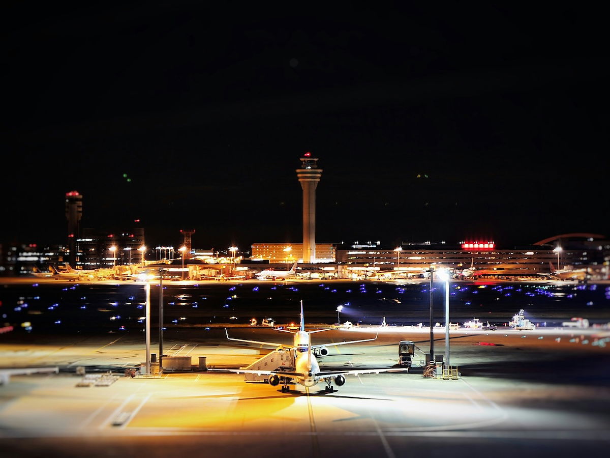 Airplanes on the tarmac at an airport at night as an example of aviation photography