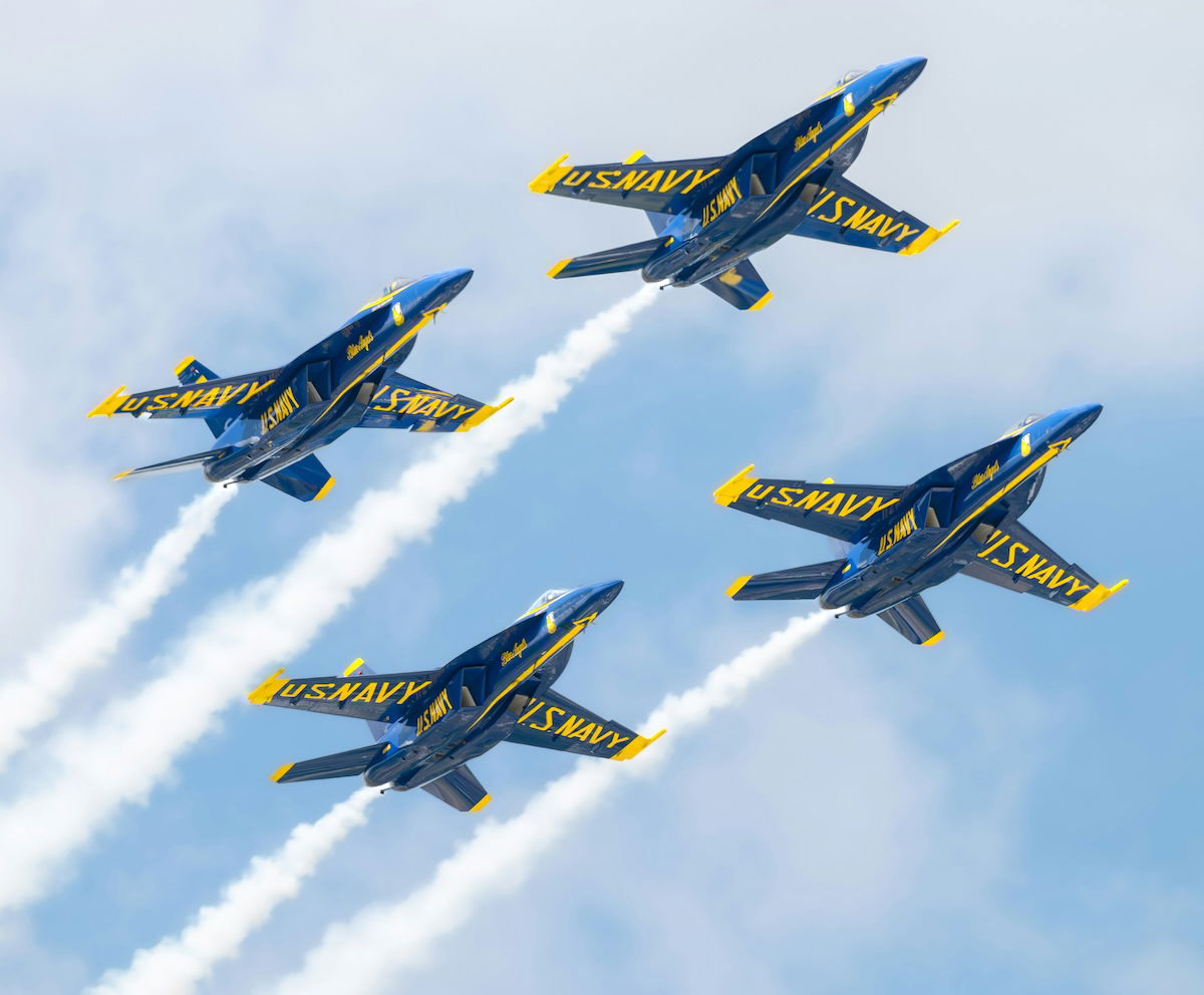 Blue Angels performing the diamond maneuver at an air show as an example of aviation photography