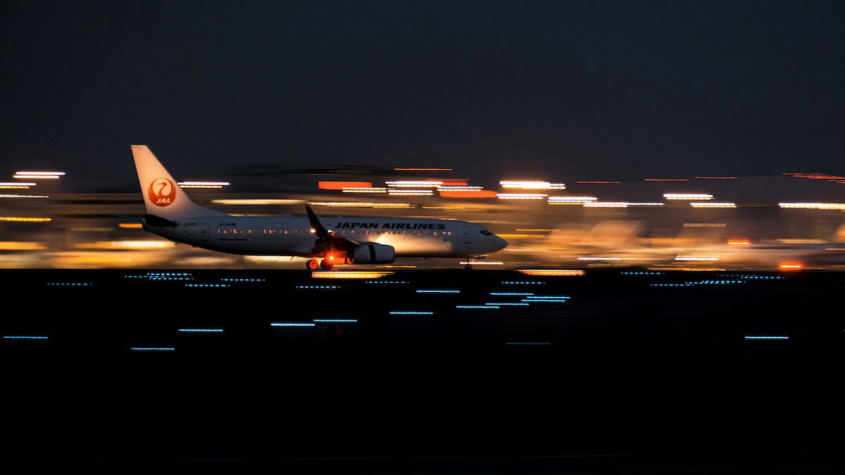 A panning shot of a commercial plane landing as an example of aviation photography