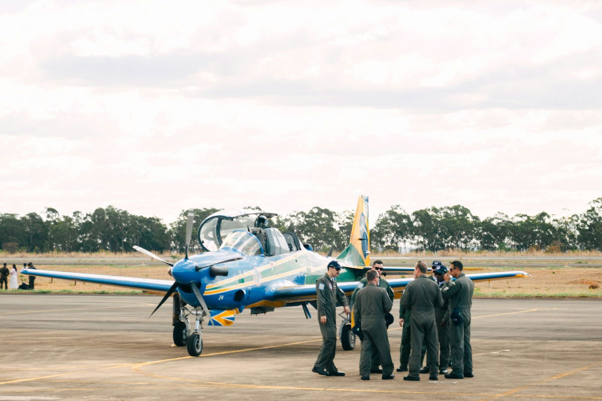 Fighter pilots gathered beside a fighter plane as an example of aviation photography