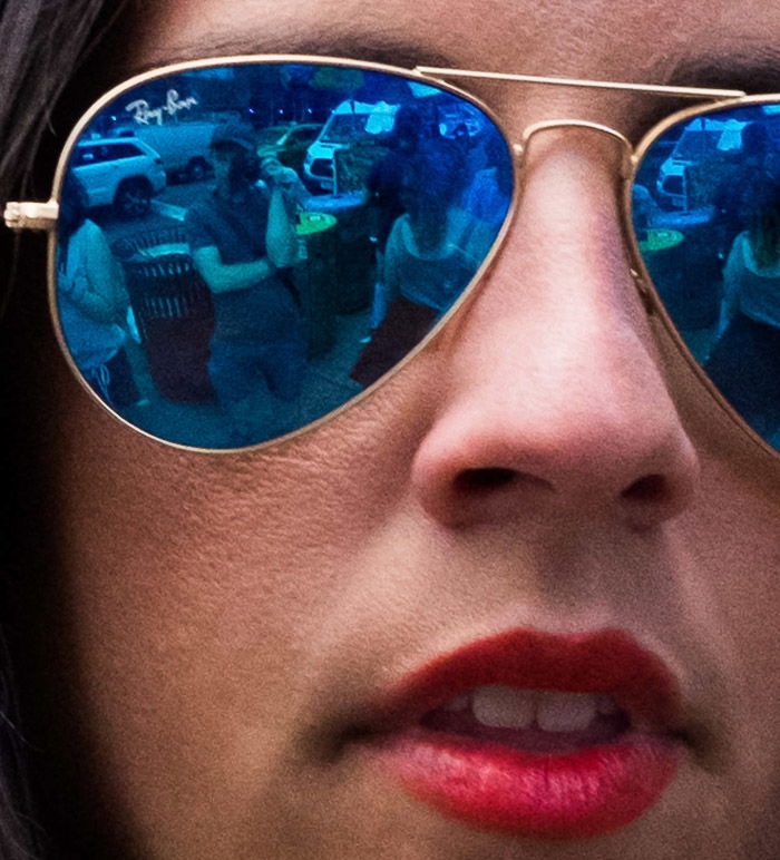 Reflection self-portrait in the lenses of a girl wearing blue polarized Ray Bans