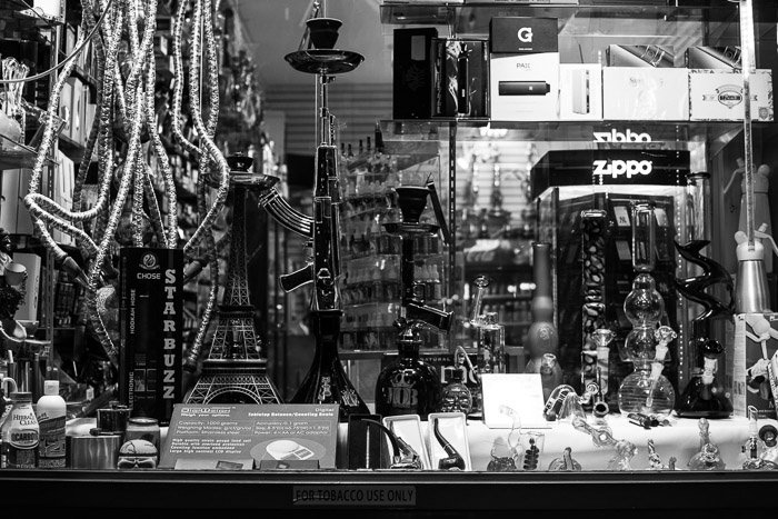 Monochrome shop window controlling reflections. Black and white street photography.